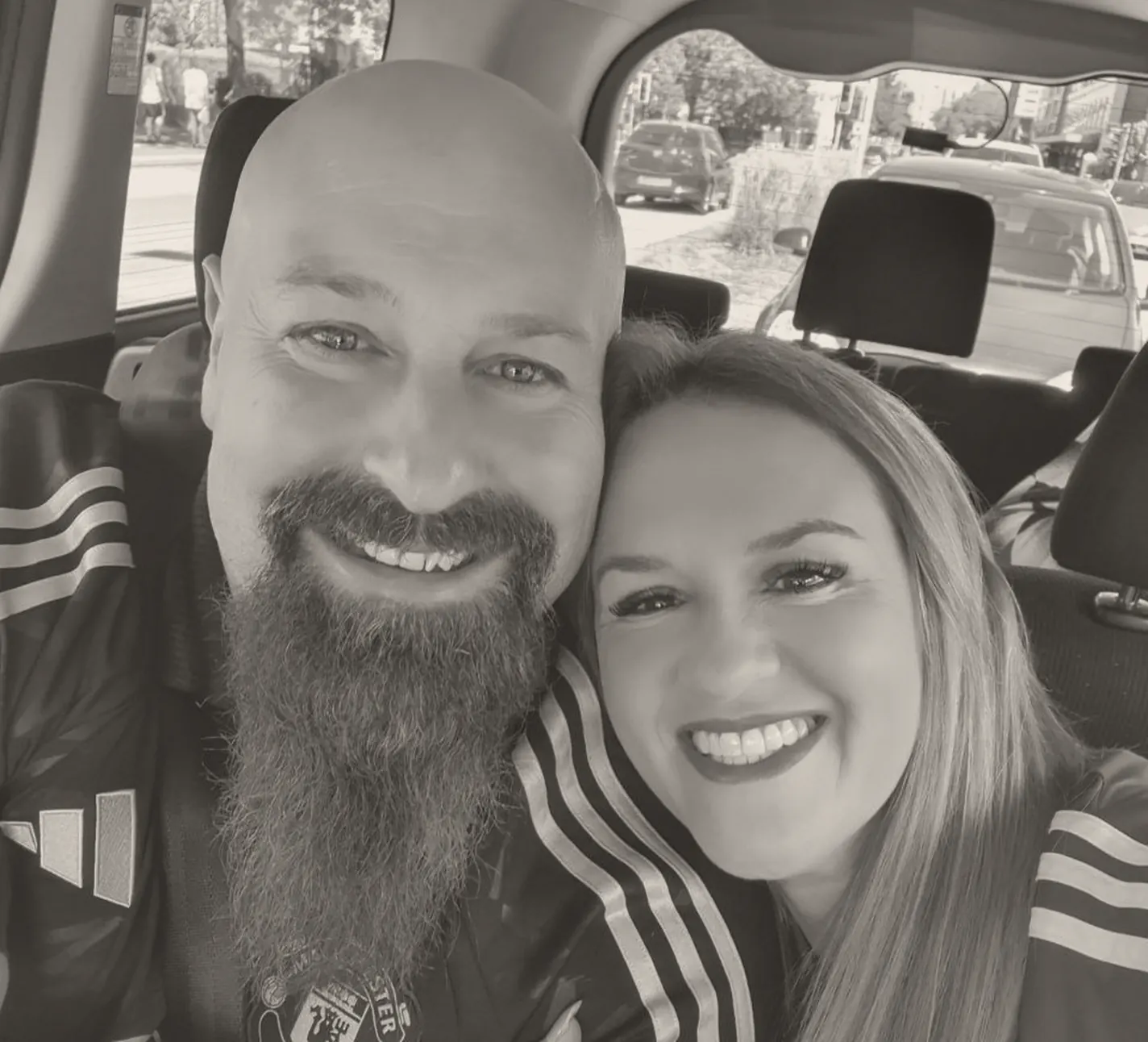 Neil Lock and Natalie Lock, co-founders, beside a car